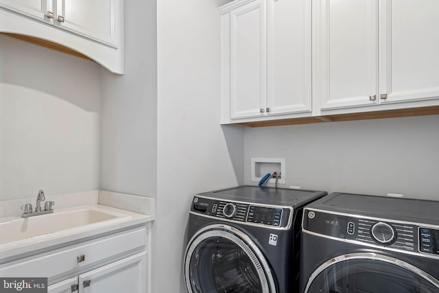 laundry room with sink, cabinets, and independent washer and dryer