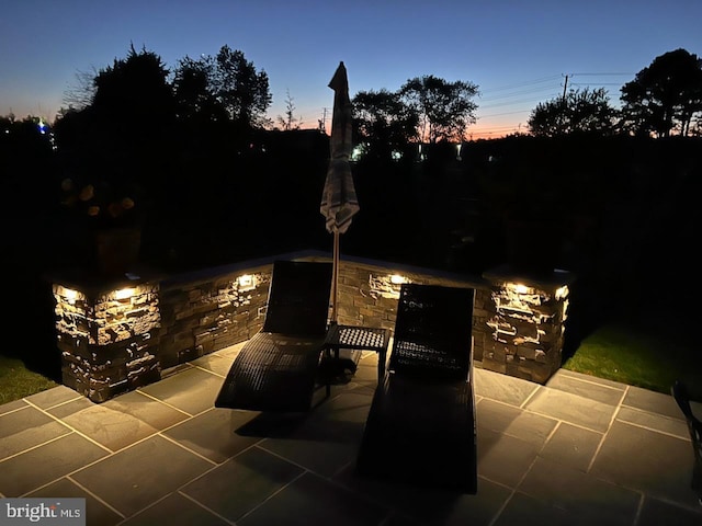 view of patio terrace at dusk