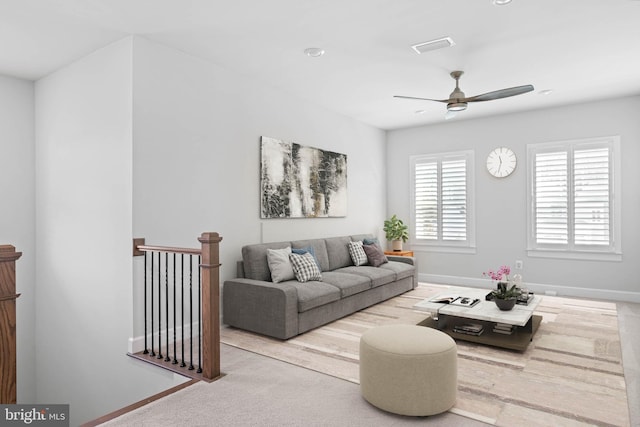 living room with ceiling fan and light colored carpet