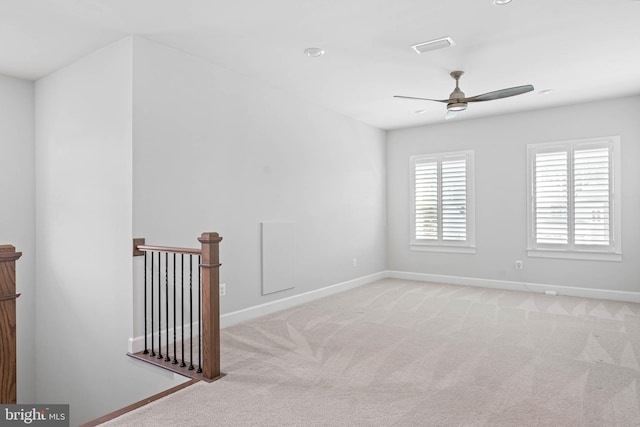 spare room with ceiling fan and light carpet