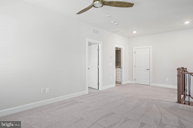 unfurnished room with ceiling fan and light colored carpet