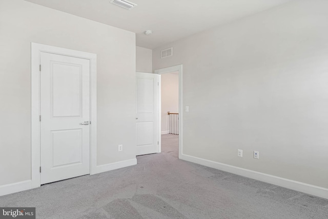 unfurnished bedroom featuring light carpet