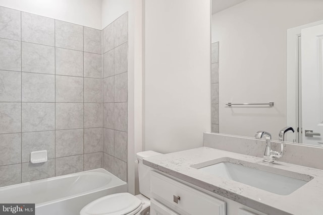 full bathroom with toilet, vanity, and tiled shower / bath