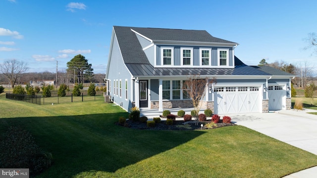 view of front of property featuring covered porch, a front lawn, and a garage