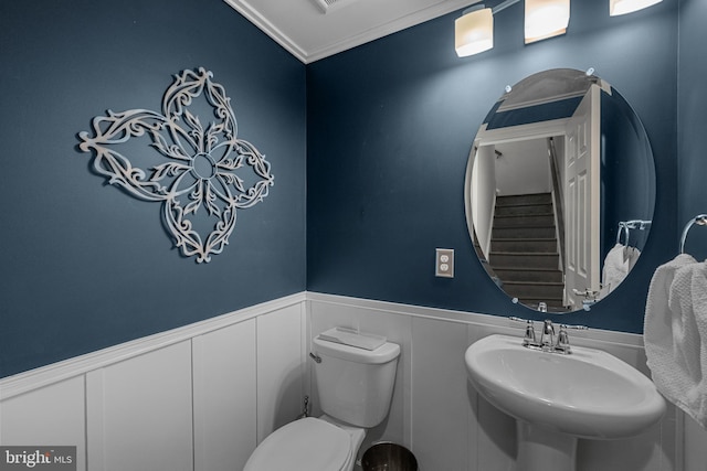 bathroom with crown molding, sink, and toilet