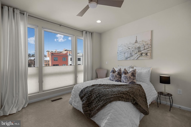 bedroom with light colored carpet and ceiling fan