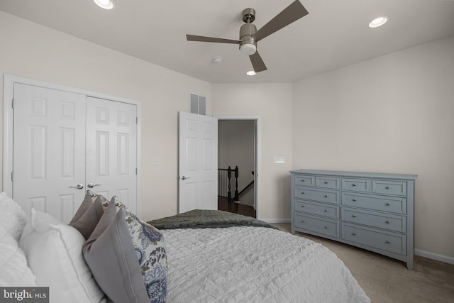 bedroom featuring ceiling fan, a closet, and light carpet