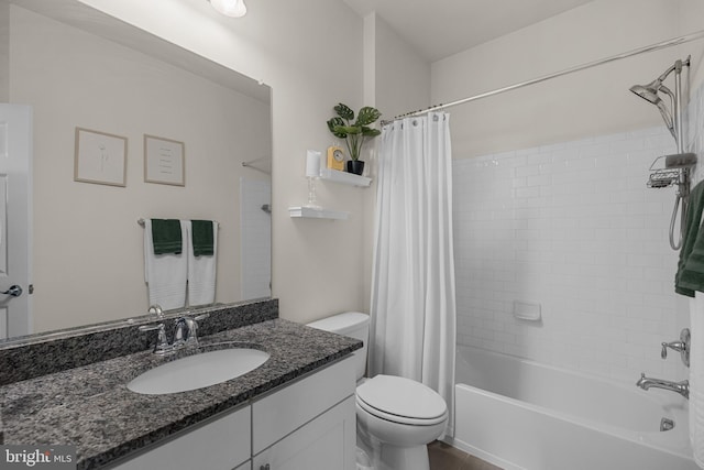 full bathroom with vanity, shower / tub combo, and toilet