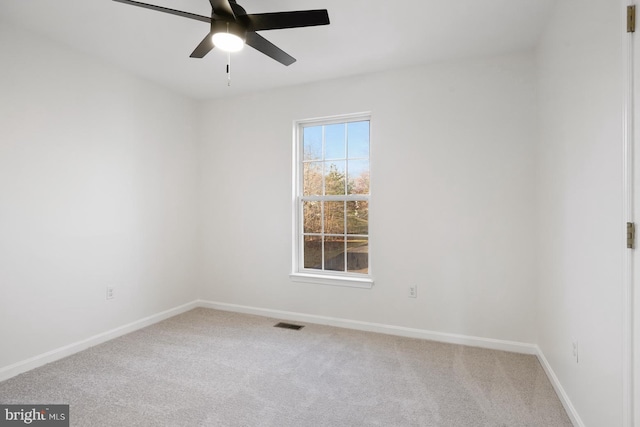 empty room with ceiling fan and carpet flooring