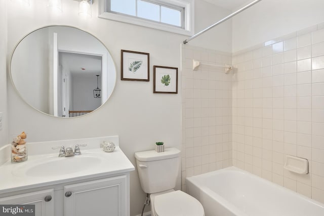 full bathroom with tiled shower / bath combo, vanity, and toilet