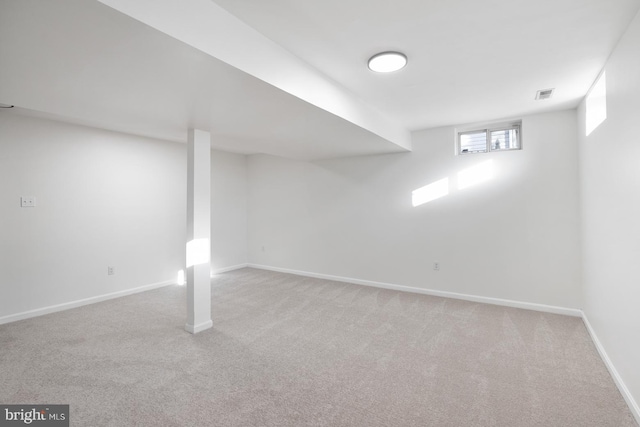 basement featuring light colored carpet