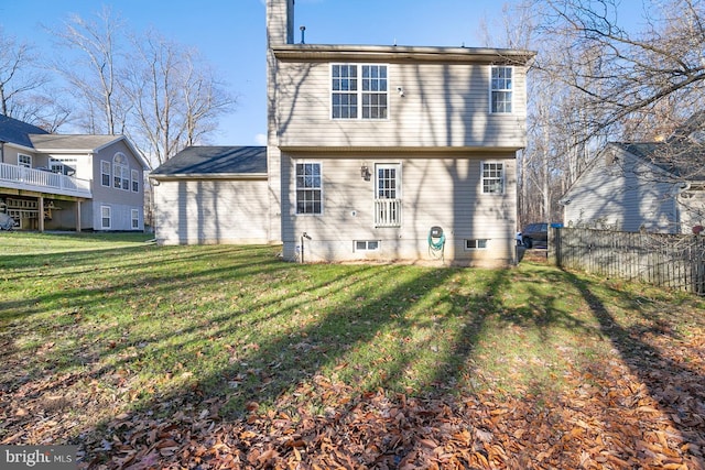 back of house featuring a yard