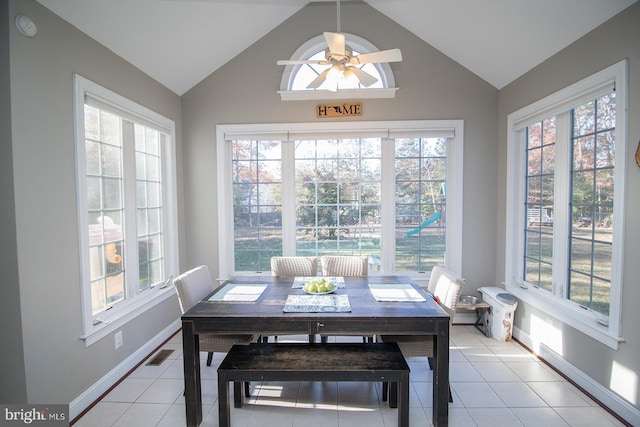 tiled dining room featuring a wealth of natural light and lofted ceiling