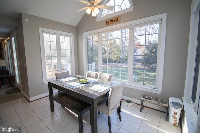 tiled dining area with ceiling fan and vaulted ceiling