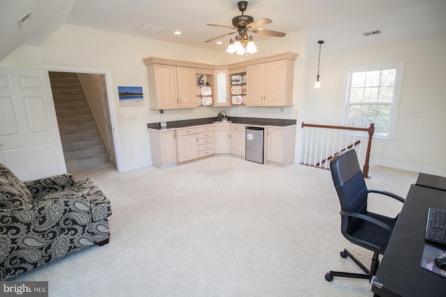 carpeted office space featuring ceiling fan