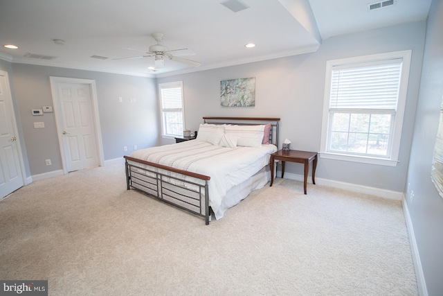 bedroom with ceiling fan, light carpet, and ornamental molding