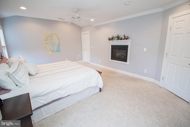 carpeted bedroom with ceiling fan and ornamental molding