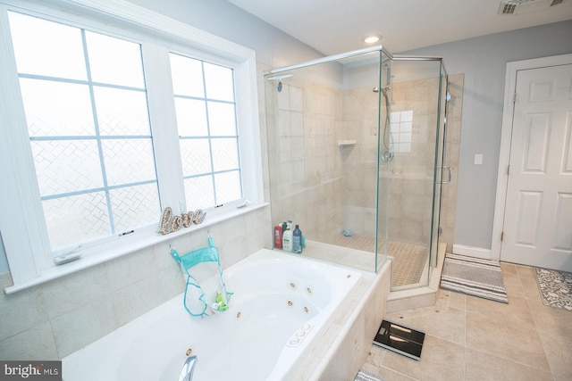 bathroom with tile patterned floors and plus walk in shower