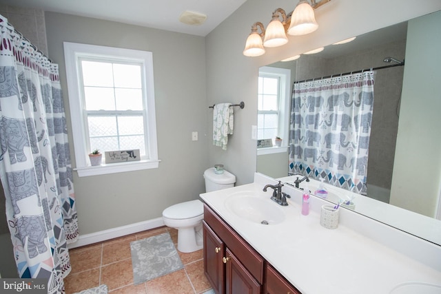 bathroom with a shower with shower curtain, vanity, and a healthy amount of sunlight