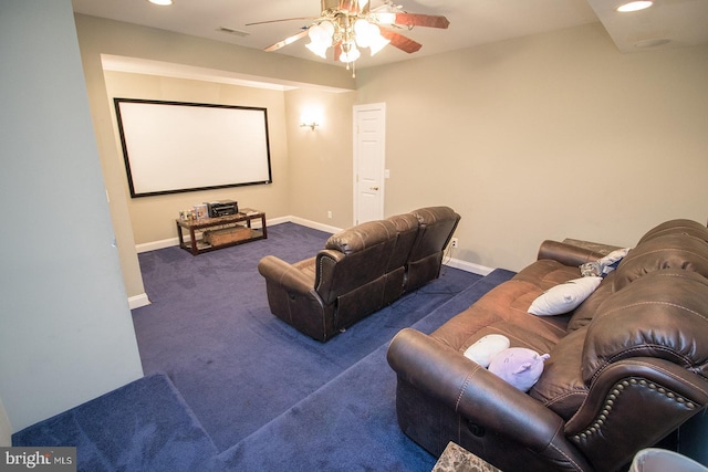 cinema room featuring dark colored carpet and ceiling fan