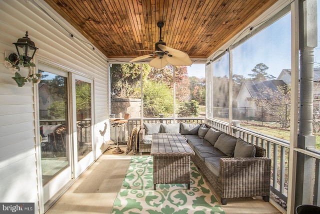 sunroom / solarium with ceiling fan, a healthy amount of sunlight, and wood ceiling