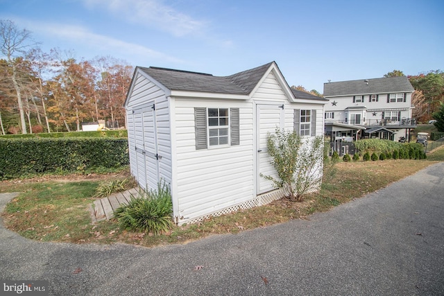 view of side of property featuring a shed