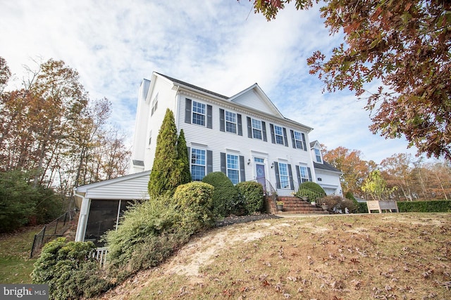 view of front of property with a sunroom