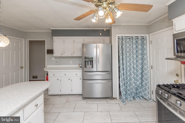 kitchen featuring white cabinetry, ornamental molding, appliances with stainless steel finishes, and ceiling fan