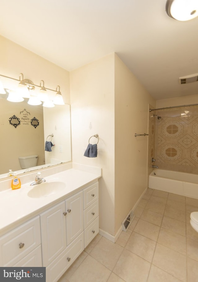 full bathroom featuring tiled shower / bath, tile patterned floors, toilet, and vanity