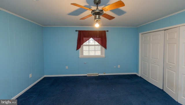 unfurnished bedroom featuring ceiling fan, ornamental molding, a closet, and dark colored carpet