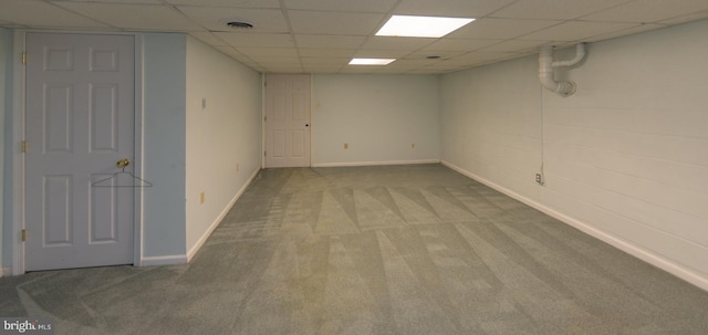 basement featuring carpet flooring and a paneled ceiling