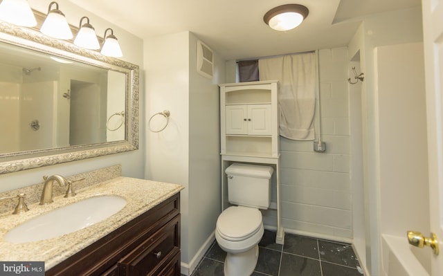 bathroom featuring tile patterned flooring, vanity, and toilet