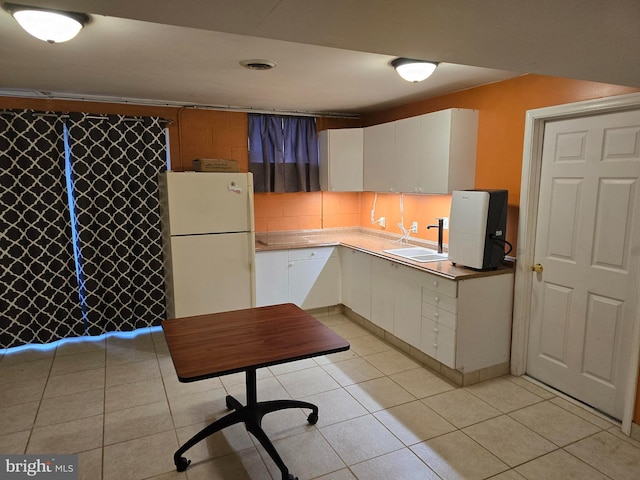 kitchen with white cabinetry, sink, tasteful backsplash, and white refrigerator