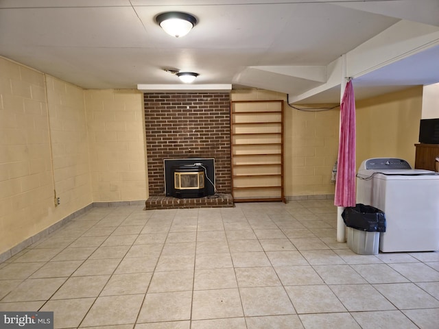 unfurnished living room with washer / clothes dryer and light tile patterned flooring