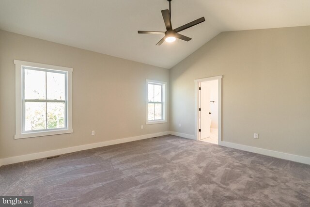 carpeted empty room with vaulted ceiling and ceiling fan