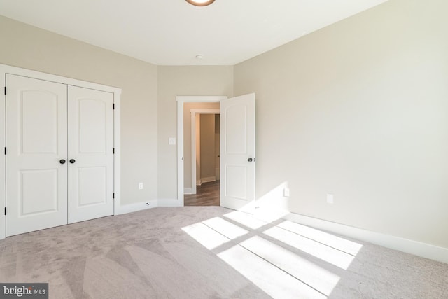 unfurnished bedroom with a closet and carpet