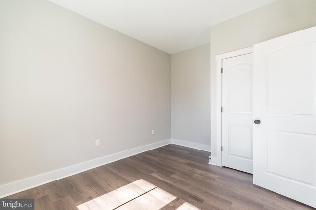 unfurnished bedroom featuring dark hardwood / wood-style flooring