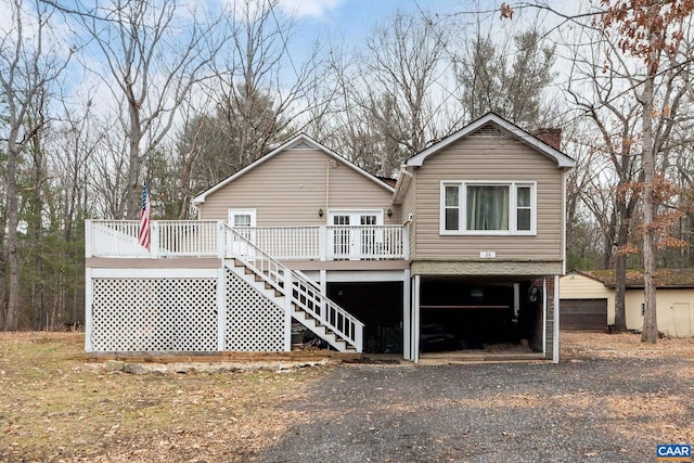 back of house featuring a wooden deck