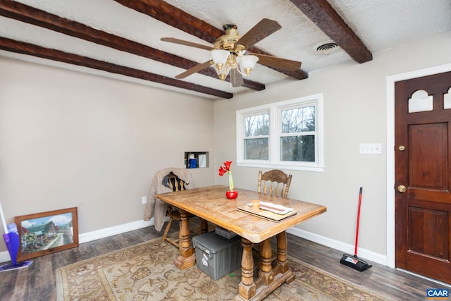 dining space with beam ceiling, ceiling fan, a textured ceiling, and hardwood / wood-style flooring