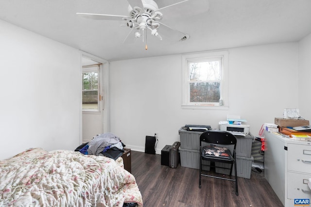 bedroom featuring ceiling fan, dark hardwood / wood-style floors, and multiple windows