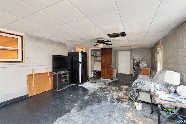 unfurnished living room with a drop ceiling and ceiling fan