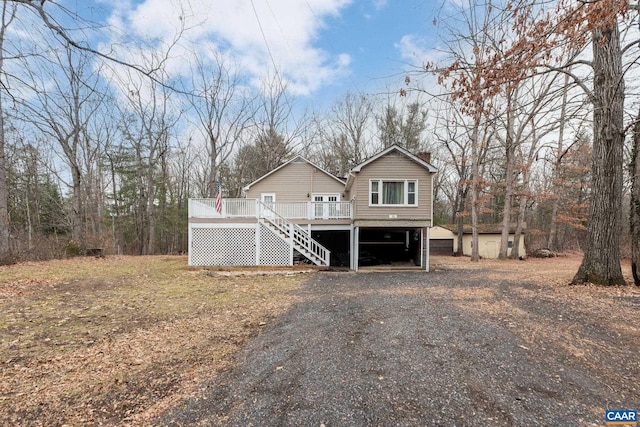 view of front of home featuring a storage shed and a wooden deck