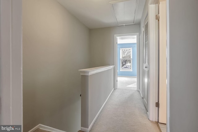 hall with light colored carpet