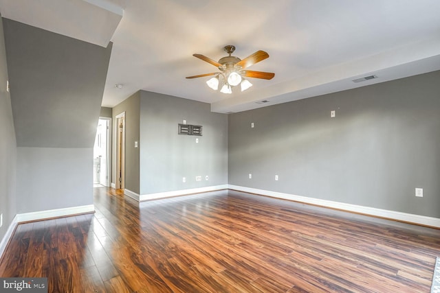 empty room featuring dark wood-type flooring and ceiling fan