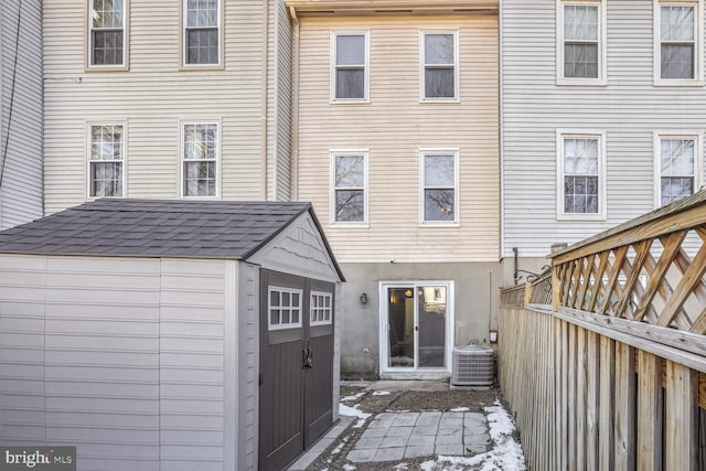 rear view of property featuring cooling unit