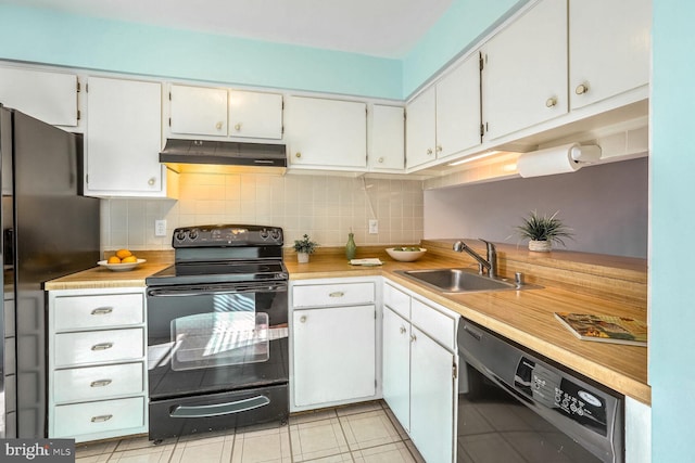 kitchen featuring sink, tasteful backsplash, black appliances, light tile patterned floors, and white cabinets