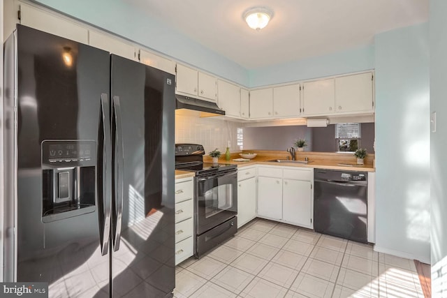 kitchen with tasteful backsplash, sink, black appliances, and cream cabinetry