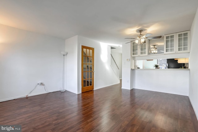 unfurnished living room featuring dark hardwood / wood-style floors and ceiling fan