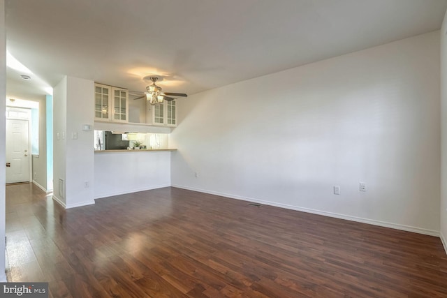 unfurnished living room with ceiling fan and dark hardwood / wood-style floors