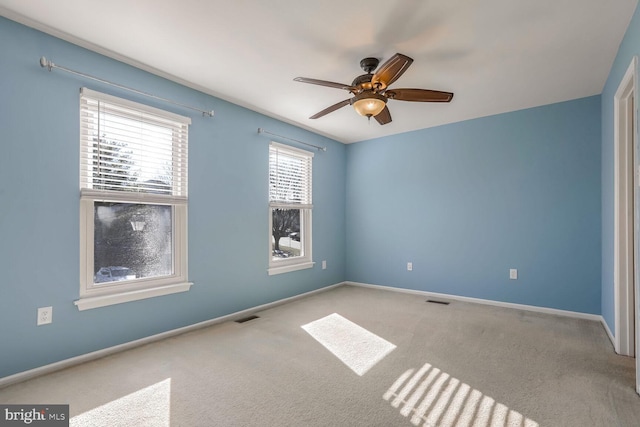 carpeted empty room with ceiling fan